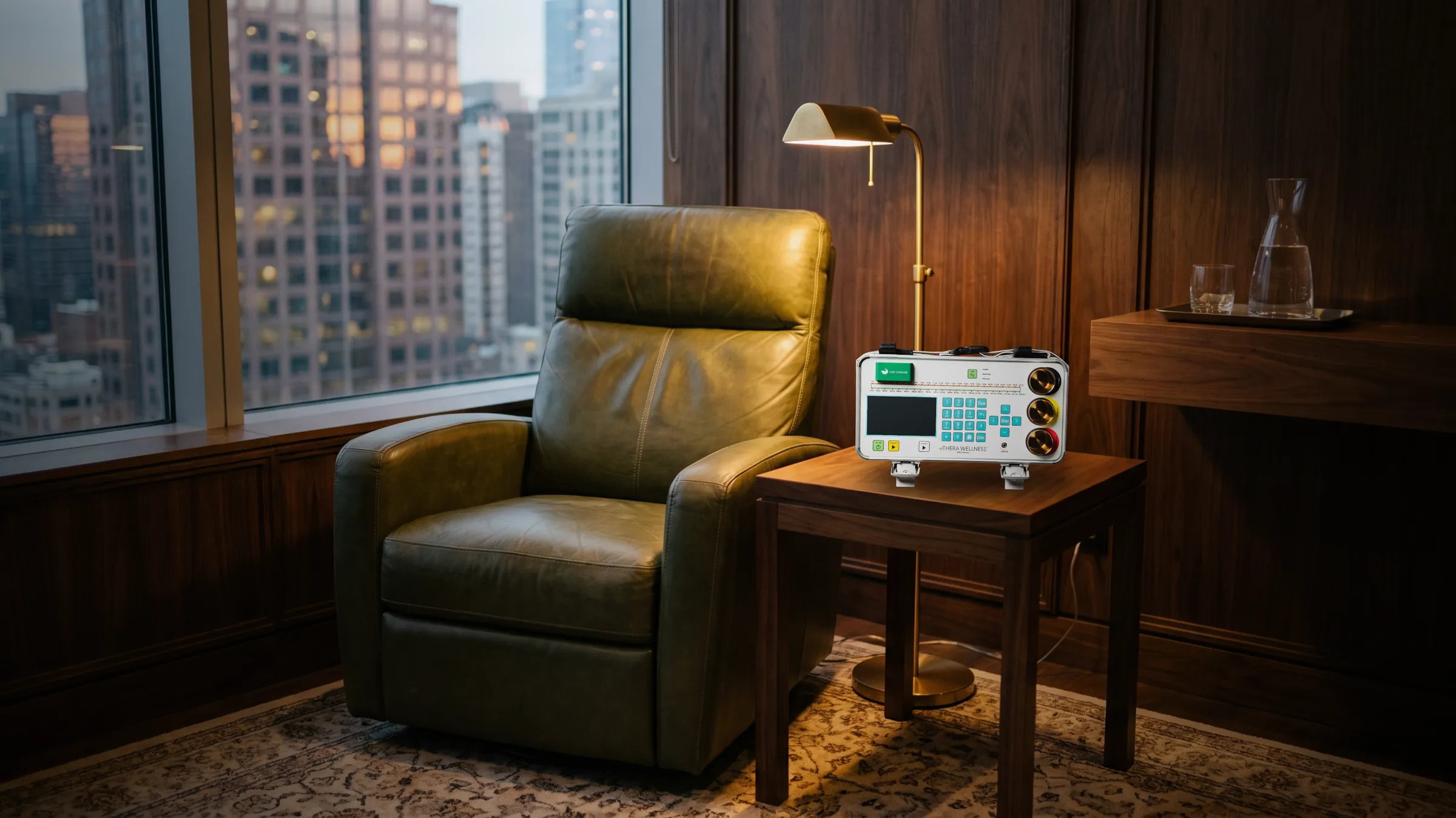 THERA device beside a leather recliner in a members’ club room at dusk